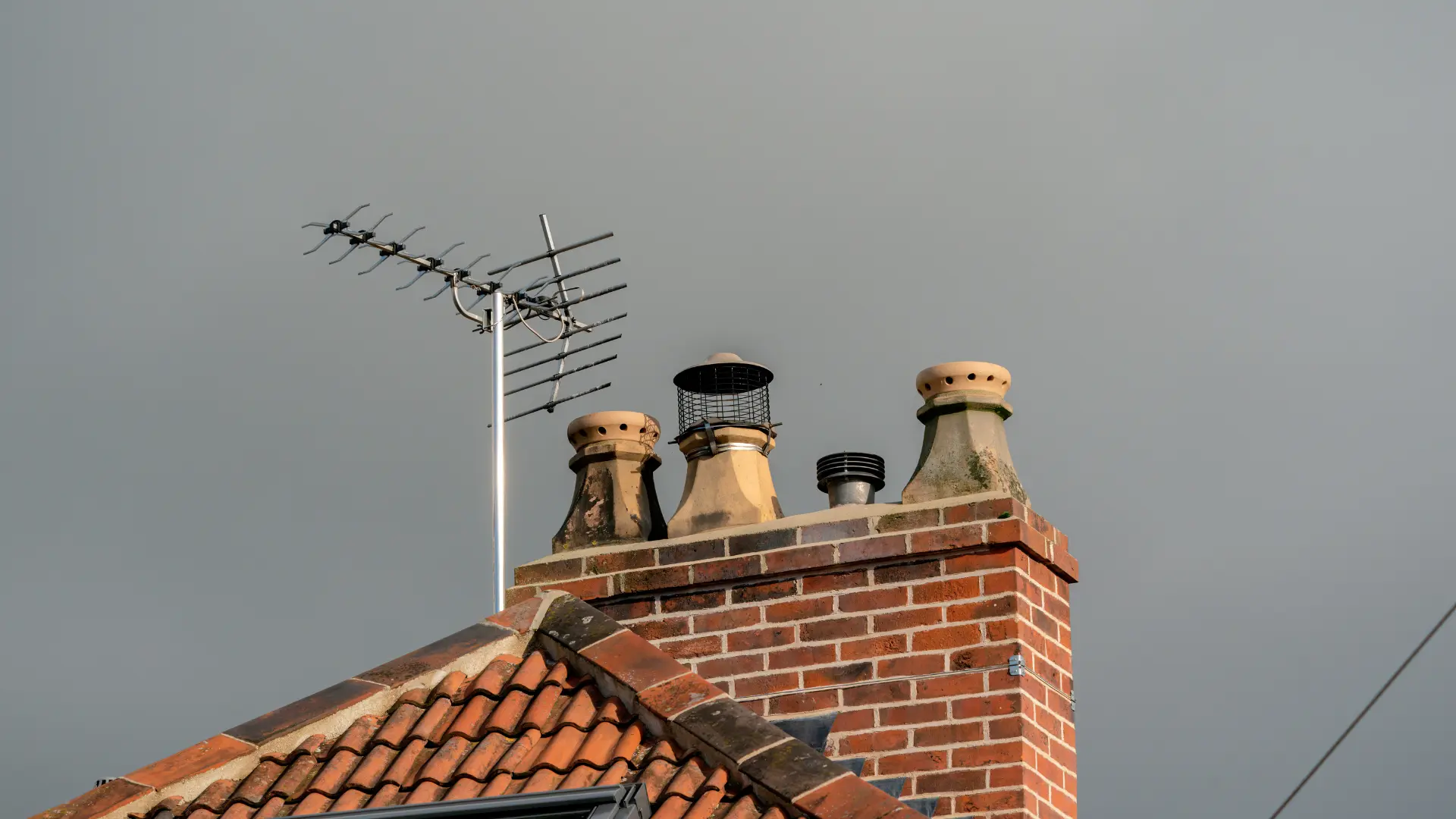 Brick chimney stack with several pots, showing the brickwork and pointing